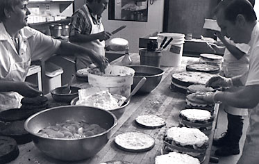 Master bakers at work using old-world craftsmanship -- everything is handmade with attention to detail.